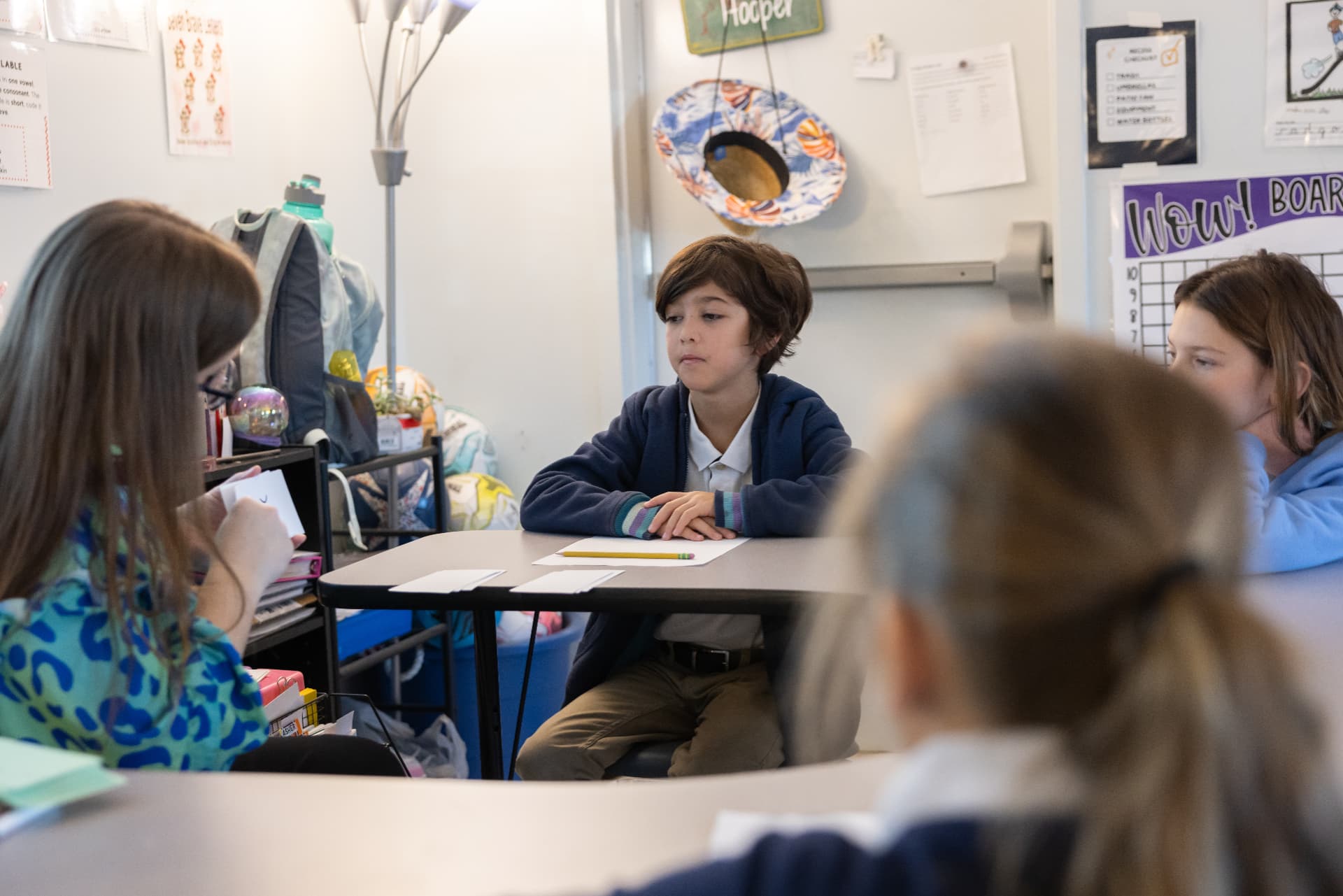 A student listening thoughtfully during a small group discussion